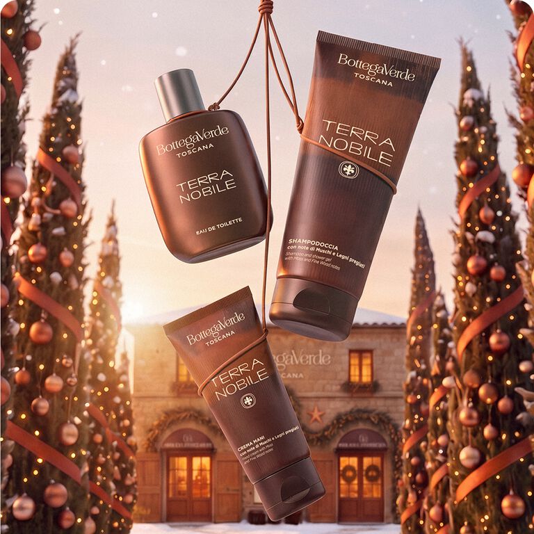Eau de toilette e prodotti uomo Terra Nobile Bottega Verde tra alberi di Natale e un borgo toscano